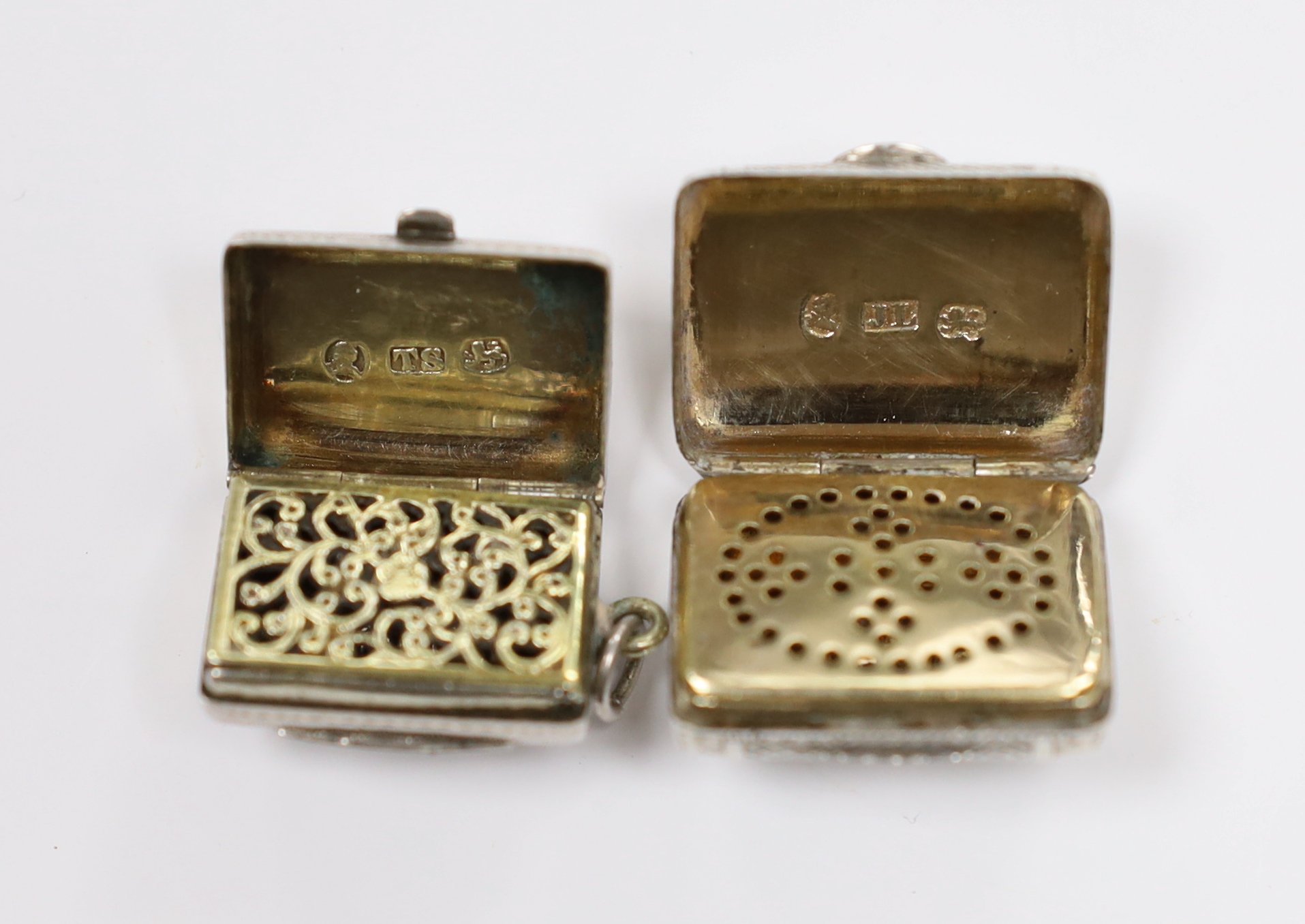 Two 19th century engraved silver vinaigrettes, modelled as satchels, John Lawrence & Co, Birmingham, 1817 and Thomas Simpson?, Birmingham, 1831, largest 24mm.